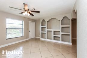 Lehigh Acres house for rent - a dining room with white shelves and a ceiling fan