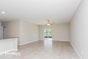 Wimauma house for rent - an empty living room with a ceiling fan