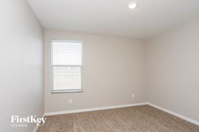 Wimauma house for rent - a bedroom with white walls and a window and carpet