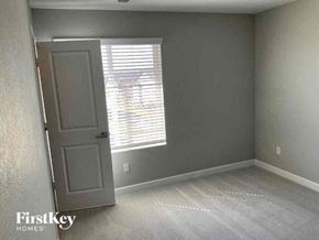 Commerce City house for rent - an empty room with a window and a door