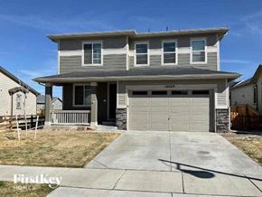Commerce City house for rent - a gray house with a white garage door