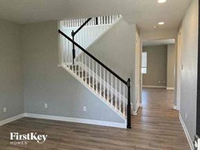 Commerce City house for rent - a staircase in a house with wood floors