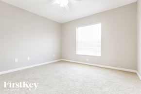 North Port house for rent - a bedroom with white carpet and a large window
