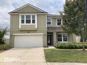 Jacksonville house for rent - a beige house with a white garage door