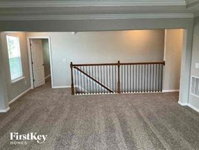 Jacksonville house for rent - an empty living room with a railing in a house