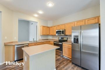 Phoenix house for rent - A kitchen with wooden cabinets and stainless steel appliances.