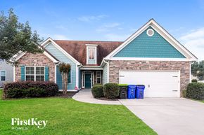 Fayetteville house for rent - A house with a blue garage door and a white driveway.