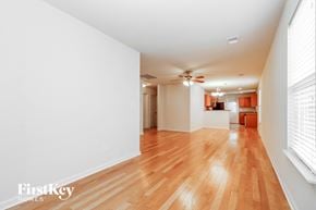 Summerville house for rent - A room with wooden floors and a ceiling fan.