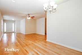 Summerville house for rent - A room with wooden floors and a chandelier.