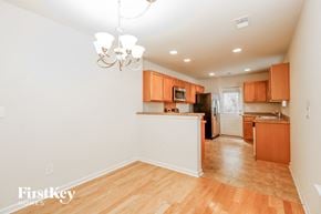 Summerville house for rent - A kitchen with wooden floors and orange cabinets.