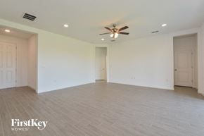 Howey In The Hills house for rent - A spacious room with a ceiling fan and lighting fixtures.