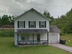 Warren house for rent - A white house with a green door and a grey roof.