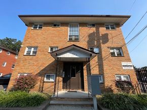 Irvington apartment for rent - A red brick building with a black gate in front.