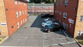 Irvington apartment for rent - A parking lot with cars parked in it.