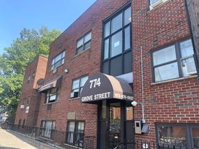 Irvington apartment for rent - The building on Grove Street has a black awning and a brick facade.