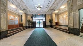 East Orange apartment for rent - A hallway with a green carpet and a staircase on the right.