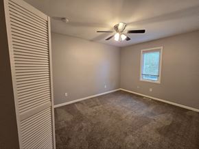 Lake Station house for rent - a bedroom with a ceiling fan and a window