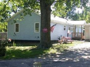 Lake Station house for rent - a white house with a stop sign on a tree