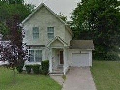 Warren house for rent - A small house with a brown door and a white garage door.