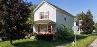 Warren house for rent - A white house with red trim and a porch.