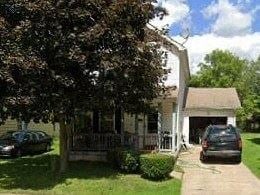Warren house for rent - A white house with a black car parked in front.