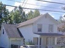 Warren house for rent - A white house with a black roof and a car parked in front.