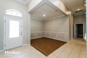 Riverview house for rent - an empty room with a white door and a wooden floor