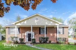 Lewisville house for rent - a brick house with a white front porch and a lawn