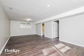 Lewisville house for rent - a living room with a hard wood floor and white walls