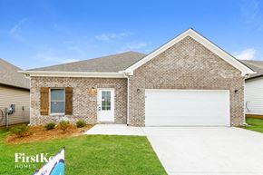 Cullman house for rent - A brick house with a white garage door and a sign that says "FirstKo Homes".