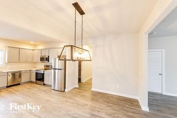 Cullman house for rent - A kitchen with a refrigerator, oven, and microwave.
