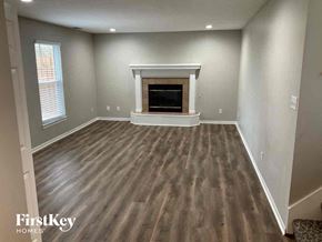 Kearney house for rent - A room with a fireplace and wood flooring.
