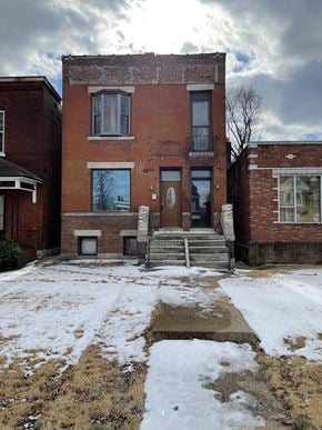 St Louis house for rent - the front of a brick building in the snow