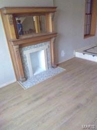 St Louis house for rent - a living room with a fireplace and a wooden floor