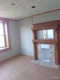 St Louis house for rent - an empty living room with a fireplace and a window