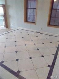 St Louis house for rent - an empty room with a tiled floor and two windows