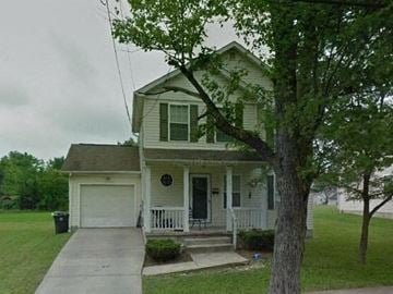 Warren house for rent - A house with a white porch and a tree in front.