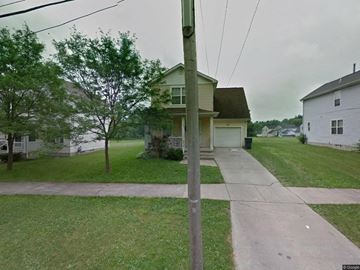 Warren house for rent - A house with a green lawn and a grey house in the background.