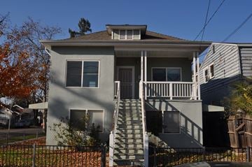 Sacramento apartment for rent - A house with a grey facade and a staircase leading to the front door.