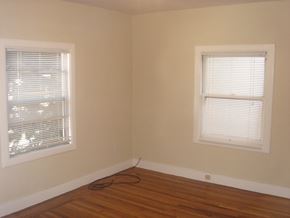 Oakland apartment for rent - the corner of a room with two windows and a wooden floor
