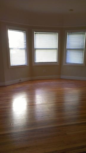 Oakland apartment for rent - a living room with a hard wood floor and three windows