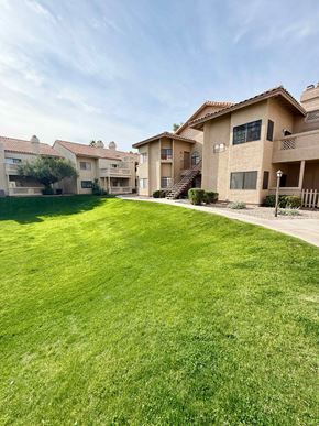 Mesa apartment for rent - A large grassy area in front of apartment buildings.
