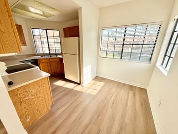 Mesa apartment for rent - A kitchen with wooden cabinets and a white refrigerator.