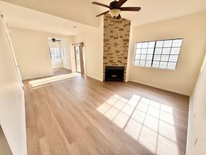 Mesa apartment for rent - A room with a fireplace and a ceiling fan.