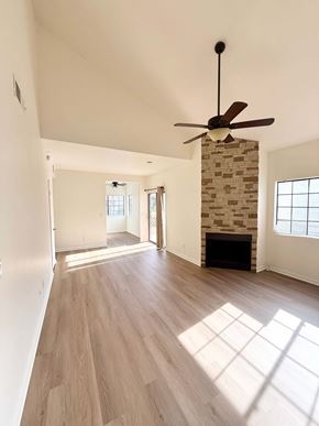 Mesa apartment for rent - A room with a fireplace and a ceiling fan.