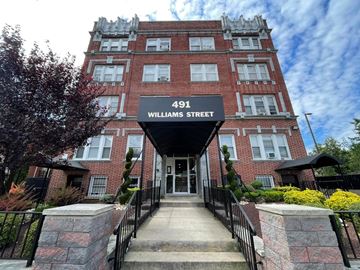 East Orange apartment for rent - A red brick building with a sign that says 491 Williams Street.