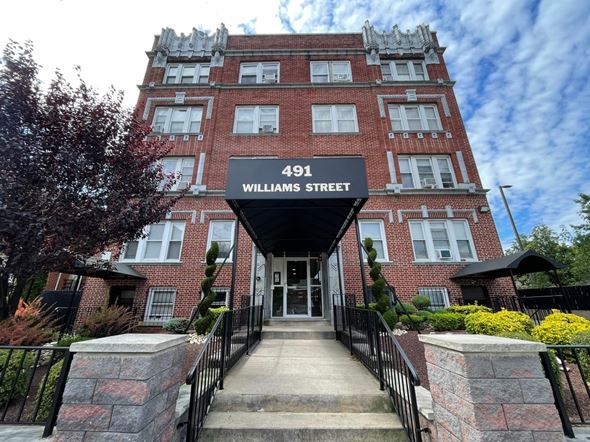 East Orange apartment for rent - A red brick building with a sign that says 491 Williams Street.