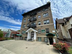 East Orange apartment for rent - A large building with a green awning and a sign on the front.