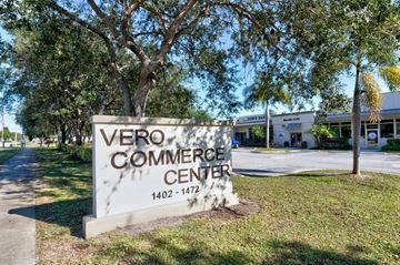 Vero Beach apartment for rent - A sign for Vero Commerce Center stands in front of a building.