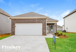 Cullman house for rent - A house with a garage door and a sign that says FirstKey.